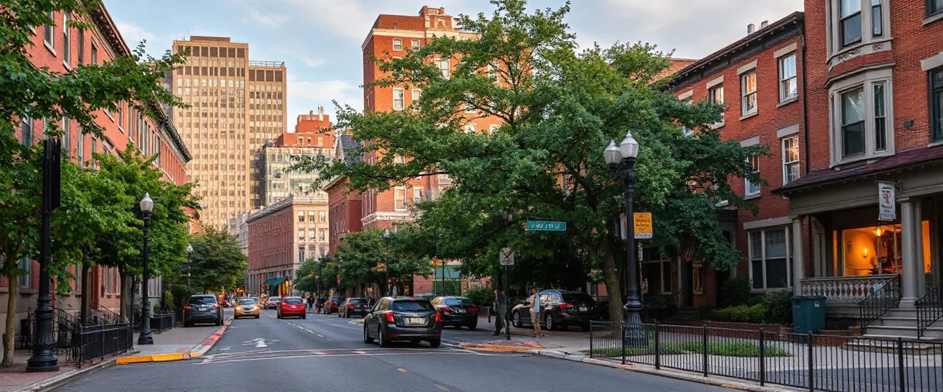 Tree-lined brick sidewalk in Boston's South End at dusk